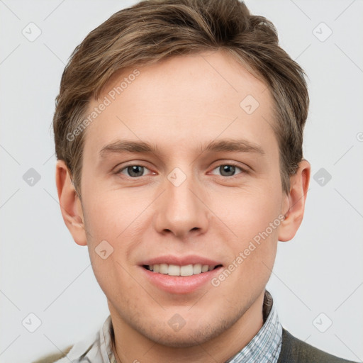 Joyful white young-adult male with short  brown hair and grey eyes