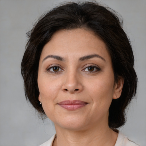Joyful white adult female with medium  brown hair and brown eyes