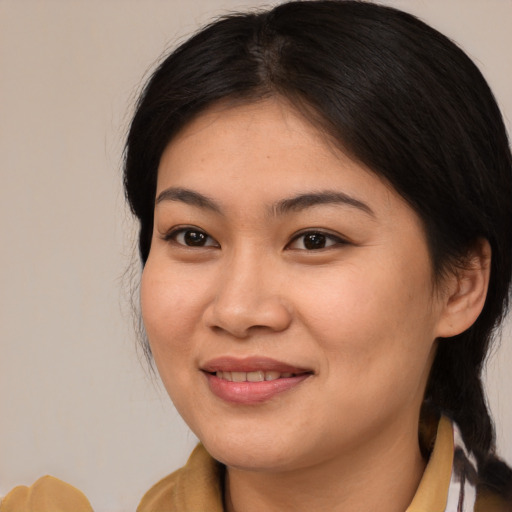 Joyful asian young-adult female with medium  brown hair and brown eyes