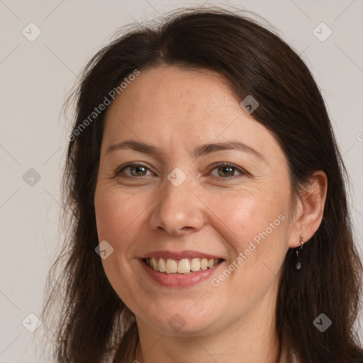 Joyful white adult female with long  brown hair and brown eyes