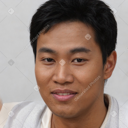 Joyful asian young-adult male with short  brown hair and brown eyes