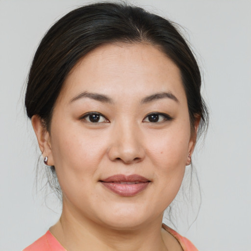 Joyful asian young-adult female with medium  brown hair and brown eyes
