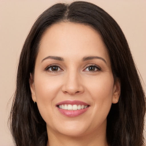 Joyful white young-adult female with long  brown hair and brown eyes