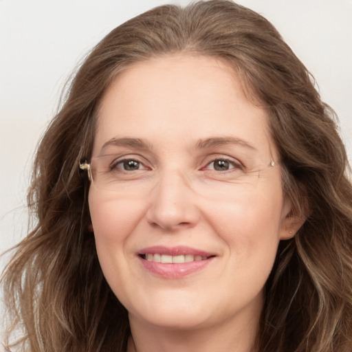 Joyful white adult female with long  brown hair and brown eyes