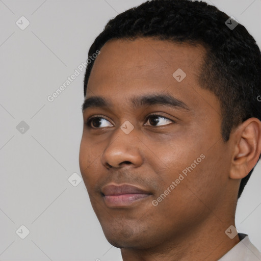 Joyful black young-adult male with short  black hair and brown eyes