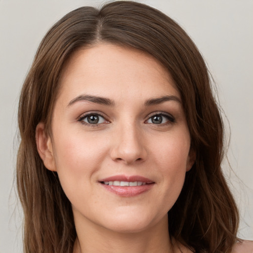 Joyful white young-adult female with long  brown hair and grey eyes