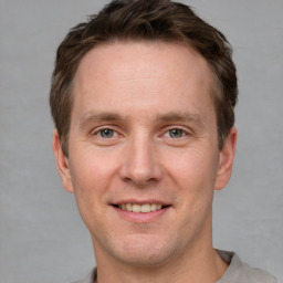 Joyful white adult male with short  brown hair and grey eyes