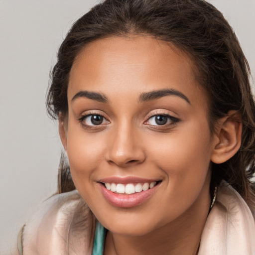 Joyful white young-adult female with long  brown hair and brown eyes