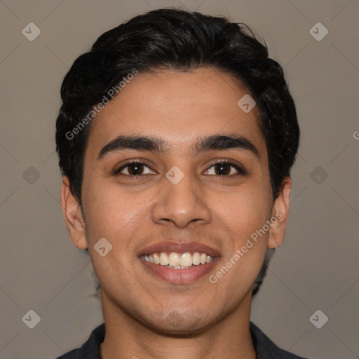 Joyful latino young-adult male with short  black hair and brown eyes