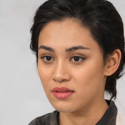 Joyful latino young-adult female with medium  brown hair and brown eyes