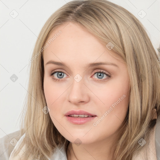 Joyful white young-adult female with long  brown hair and blue eyes