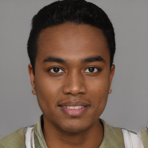 Joyful black young-adult male with short  black hair and brown eyes