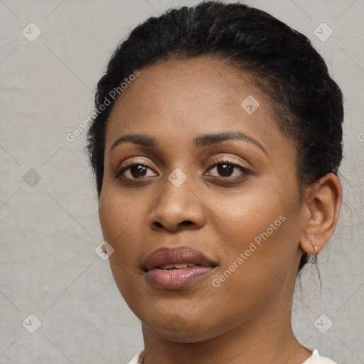 Joyful black young-adult female with short  black hair and brown eyes