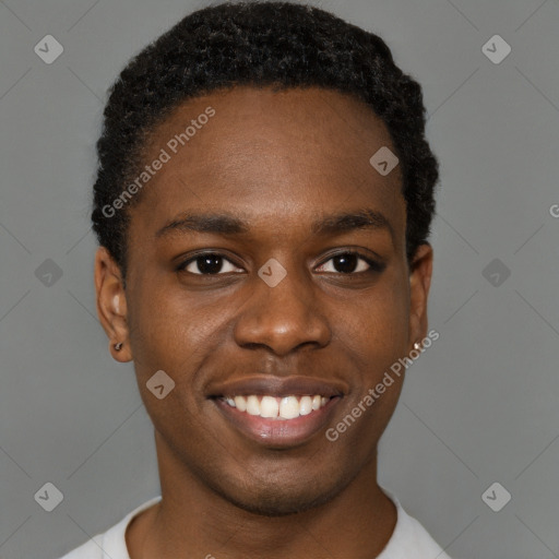 Joyful black young-adult male with short  black hair and brown eyes