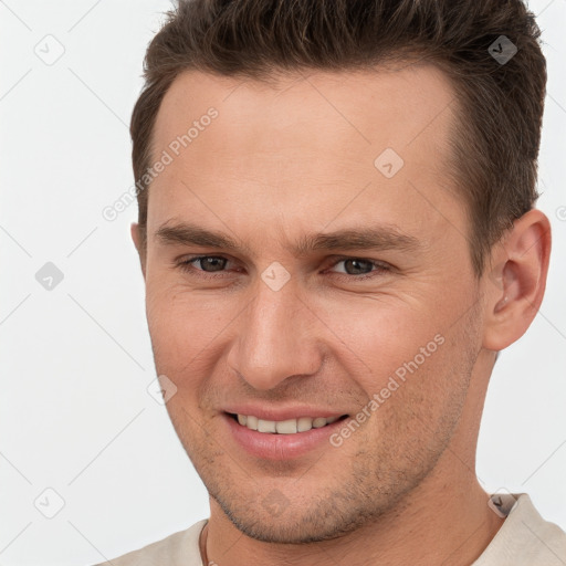 Joyful white young-adult male with short  brown hair and brown eyes