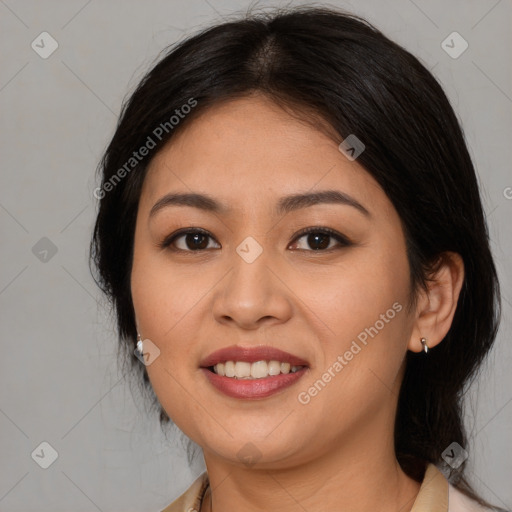 Joyful latino young-adult female with medium  brown hair and brown eyes