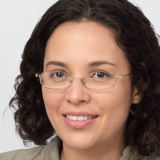 Joyful white adult female with medium  brown hair and brown eyes