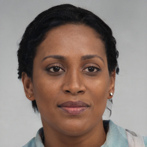 Joyful black young-adult female with medium  black hair and brown eyes