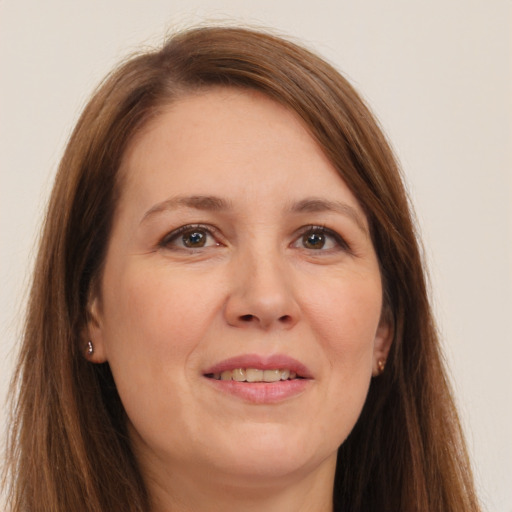 Joyful white adult female with long  brown hair and brown eyes