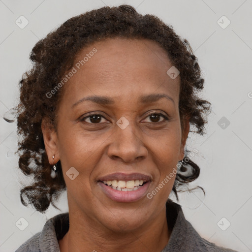 Joyful black adult female with medium  brown hair and brown eyes