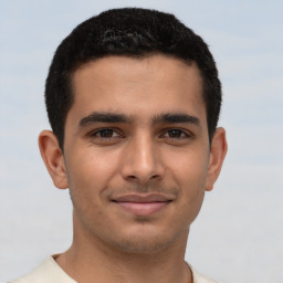 Joyful latino young-adult male with short  brown hair and brown eyes