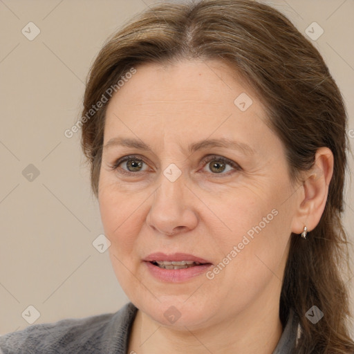 Joyful white adult female with medium  brown hair and brown eyes