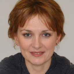 Joyful white adult female with medium  brown hair and brown eyes