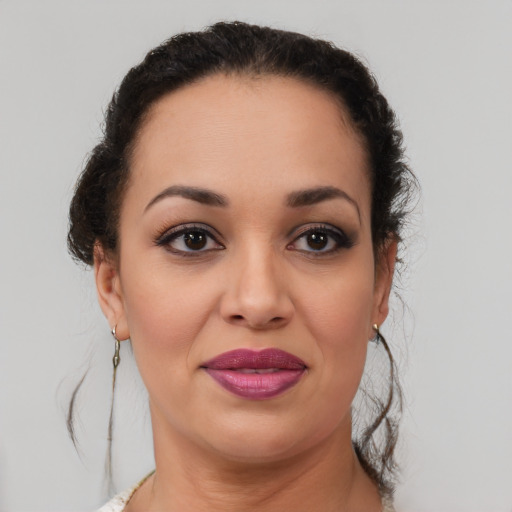 Joyful latino young-adult female with medium  brown hair and brown eyes