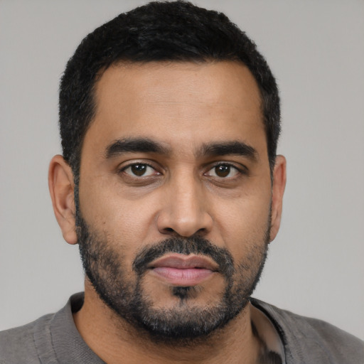 Neutral latino young-adult male with short  black hair and brown eyes