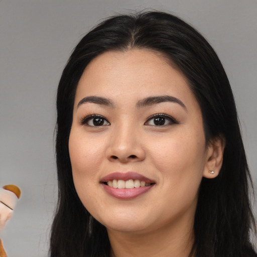 Joyful asian young-adult female with long  black hair and brown eyes