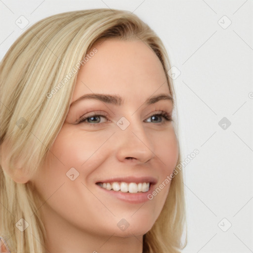 Joyful white young-adult female with long  blond hair and blue eyes