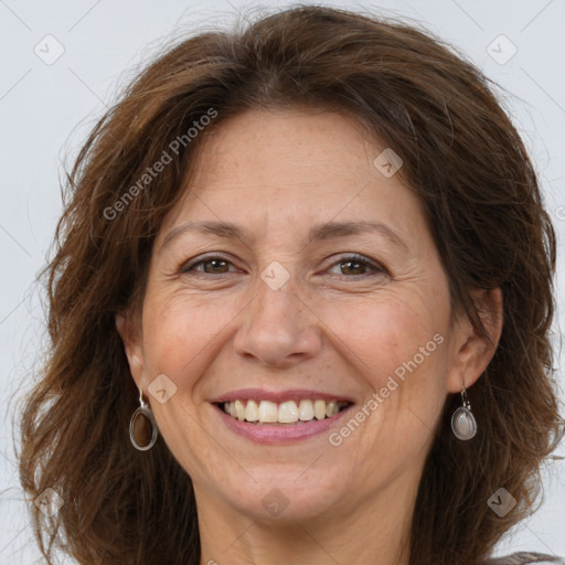 Joyful white adult female with long  brown hair and brown eyes