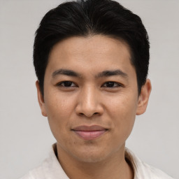 Joyful asian young-adult male with short  black hair and brown eyes