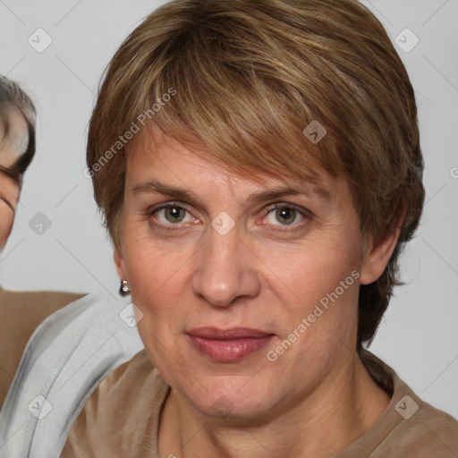 Joyful white adult female with medium  brown hair and blue eyes