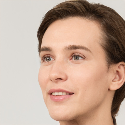 Joyful white young-adult female with short  brown hair and grey eyes