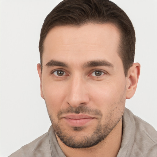 Joyful white young-adult male with short  brown hair and brown eyes