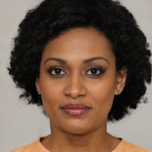 Joyful latino young-adult female with medium  black hair and brown eyes