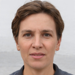 Joyful white adult female with short  brown hair and grey eyes