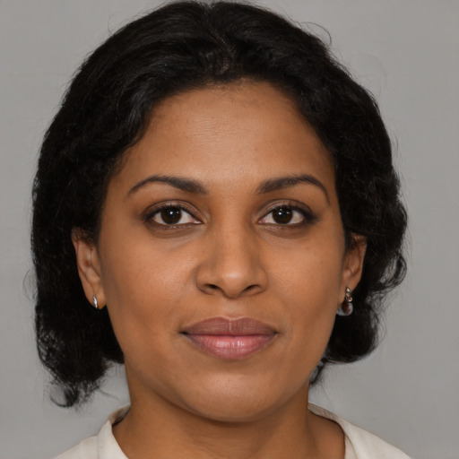 Joyful black young-adult female with medium  brown hair and brown eyes