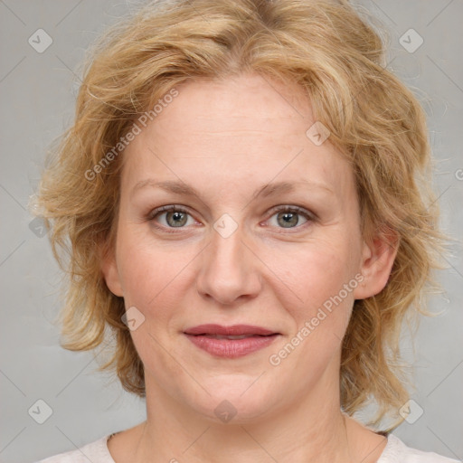 Joyful white adult female with medium  brown hair and blue eyes