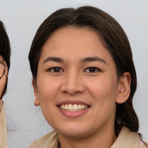 Joyful white young-adult female with medium  brown hair and brown eyes