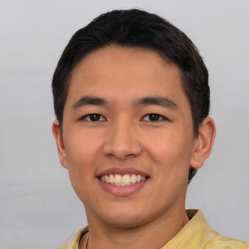 Joyful asian young-adult male with short  black hair and brown eyes