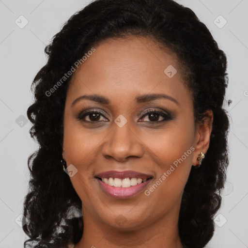 Joyful black young-adult female with long  brown hair and brown eyes