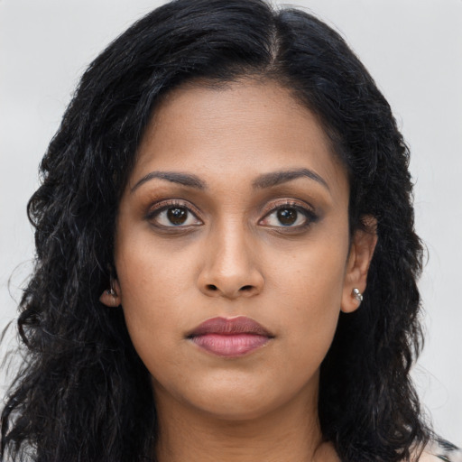 Joyful latino young-adult female with long  black hair and brown eyes