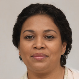 Joyful latino adult female with medium  brown hair and brown eyes
