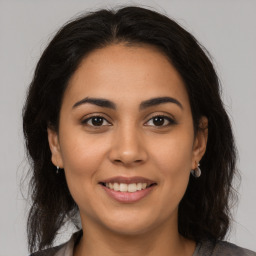 Joyful latino young-adult female with long  brown hair and brown eyes