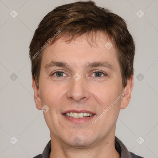 Joyful white adult male with short  brown hair and brown eyes