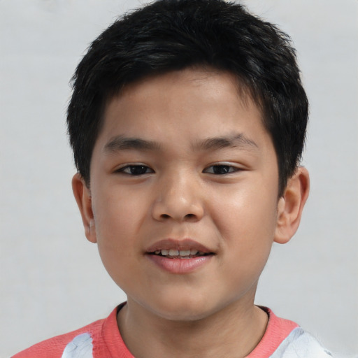 Joyful asian child male with short  brown hair and brown eyes