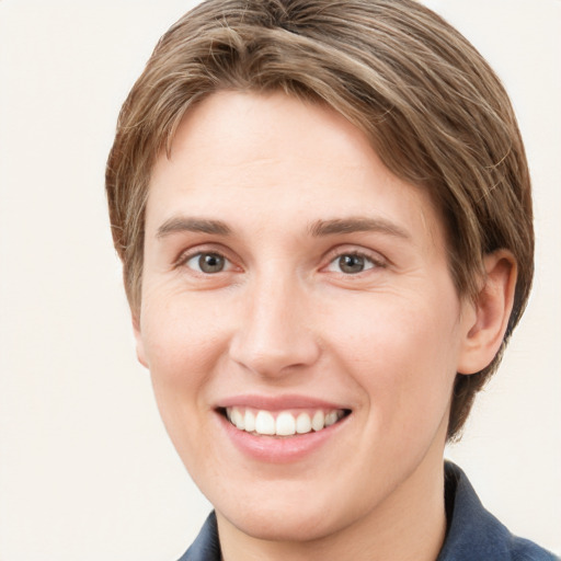 Joyful white young-adult female with short  brown hair and grey eyes