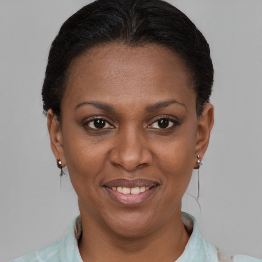 Joyful black adult female with short  brown hair and brown eyes